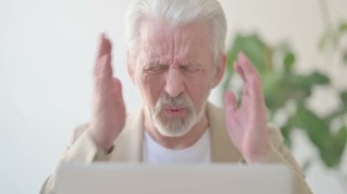 Close Up of Senior Old Man having Headache while Working on Laptop