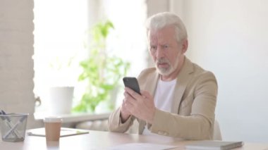Upset Senior Old Man Reacting to Loss on Smartphone