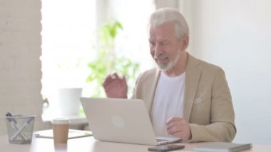 Senior Old Man Talking on Video Call on Laptop in Office
