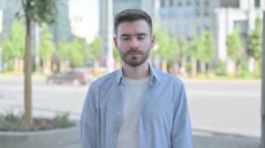 Outdoor Portrait of Man with Ok Sign