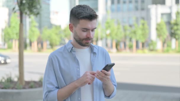 Man Celebrating Online Success Smartphone Outdoor — Video