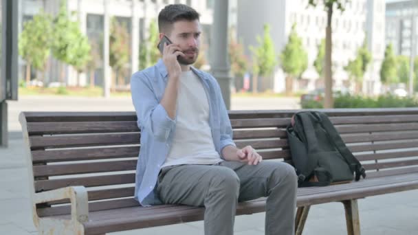Angry Man Talking Phone While Sitting Bench — Video