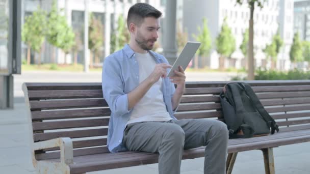 Man Celebrating Online Win Tablet While Sitting Bench — 图库视频影像