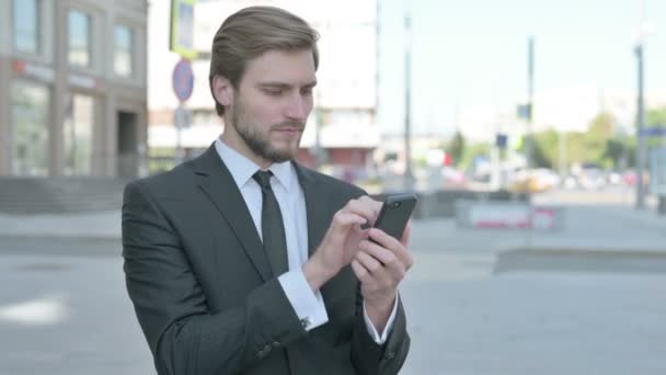 Middle Aged Businessman Browsing Internet Smartphone Outdoor — Stockvideo