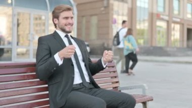Tense Middle Aged Businessman Feeling Frustrated while Sitting Outdoor on Bench