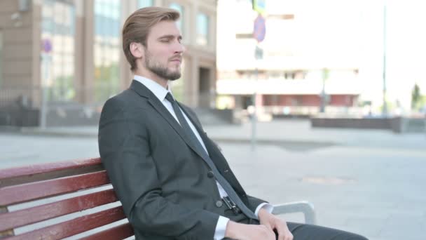 Businessman Looking Camera While Sitting Bench — Stockvideo