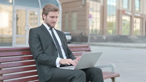 Middle Aged Businessman Celebrating Success Laptop While Sitting Outdoor Bench — Stockvideo