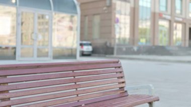 Middle Aged Businessman Coming and Sitting on Bench Outdoor