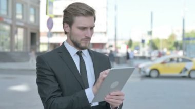 Portrait of Middle Aged Businessman using Digital Tablet Outdoor