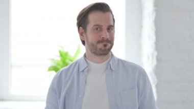 Portrait of Mature Man Shaking Head in Denial 