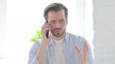 Mature Man Talking Angrily on Smartphone