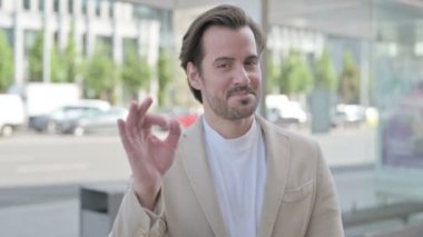 Outdoor Portrait of Man with Ok Sign