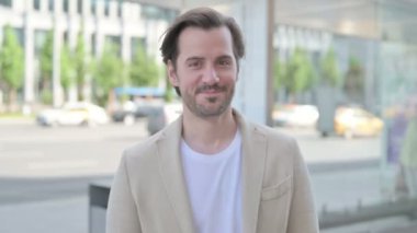 Outdoor Portrait of Agree Man Shaking Head in Approval 