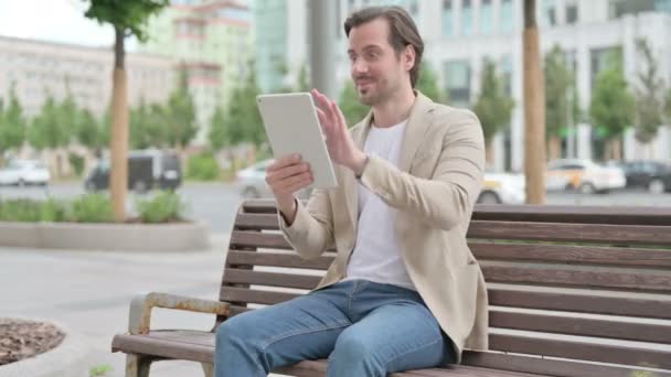 Man Celebrating Online Win Tablet While Sitting Bench — Stockvideo