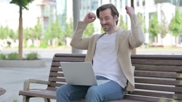 Man Celebrating Success Laptop While Sitting Bench — Stok video