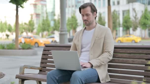 Coughing Man Using Laptop While Sitting Bench — Stockvideo