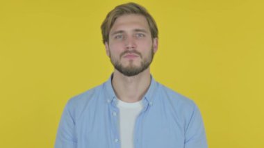 Approval by Casual Young Man, Shaking Head on Yellow Background 