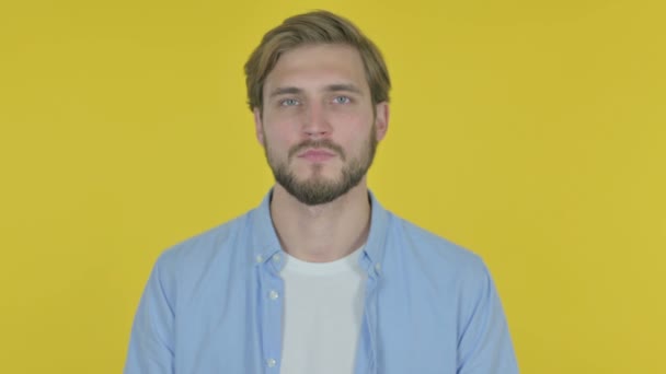 Serious Casual Young Man Yellow Background — Stockvideo