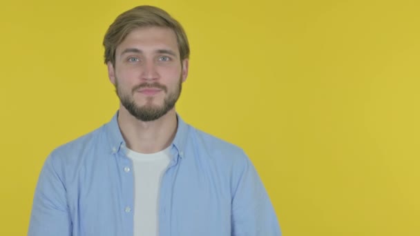 Casual Young Man Showing Side Yellow Background — стоковое видео