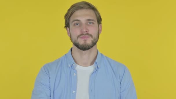 Casual Young Man Pointing Camera Yellow Background — стоковое видео