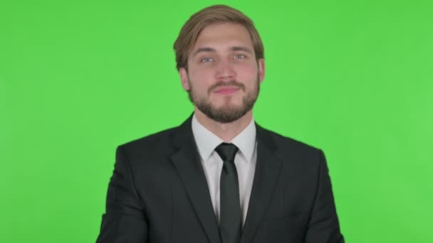 Young Adult Businessman Pointing Camera Green Background — Stockvideo