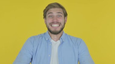 Casual Young Man Shouting and Screaming on Yellow Background 
