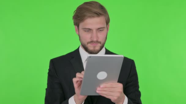 Young Adult Businessman Using Digital Tablet Green Background — Stock video
