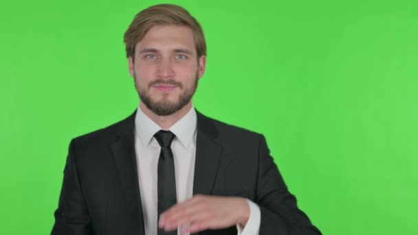 Young Adult Businessman Showing Side Green Background — Stock video