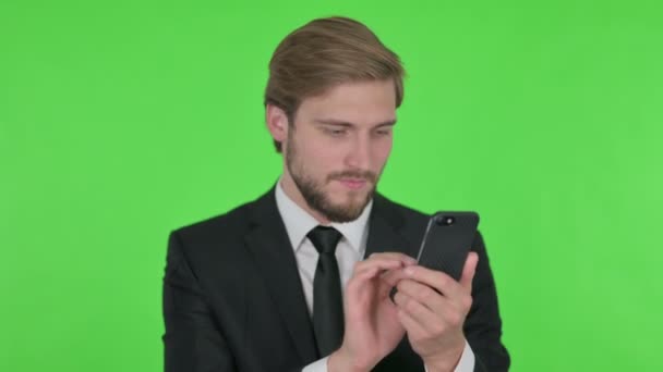 Young Adult Businessman Celebrating Smartphone Green Background — Stock video