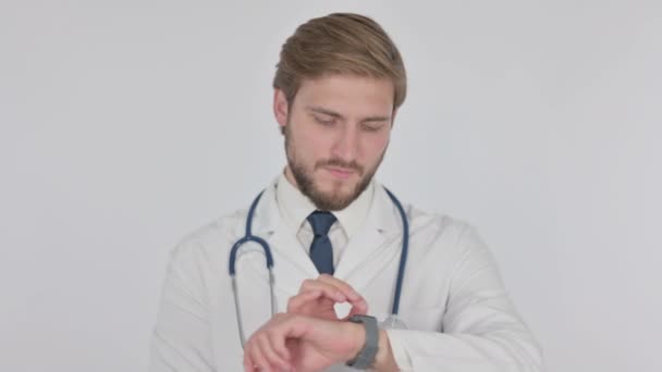 Young Adult Doctor Using Smartwatch White Background — Wideo stockowe