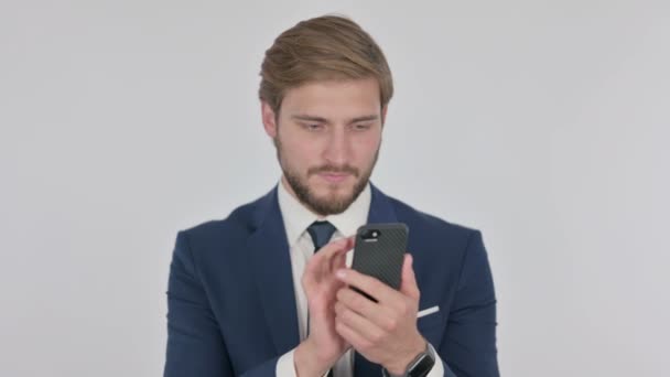 Young Adult Businessman Browsing Smartphone White Background — ストック動画