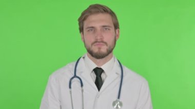 Denying Young Adult Doctor in Rejection on Green Background 