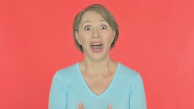 Surprised Senior Old Woman Feeling Amazed on Red Background 