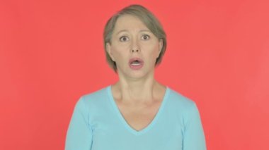 Shocked Senior Old Woman on Red Background 