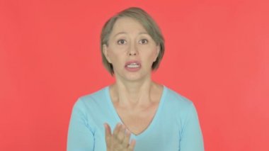 Angry Senior Old Woman Arguing on Red Background 