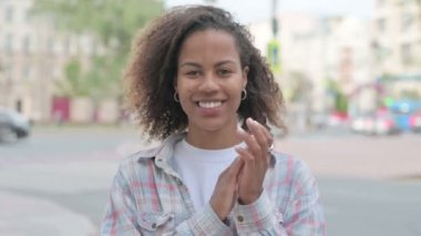 Young African Woman Clapping in Appreciation Outdoor