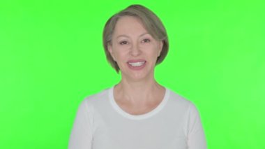 Smiling Senior Old Woman on Green Background 