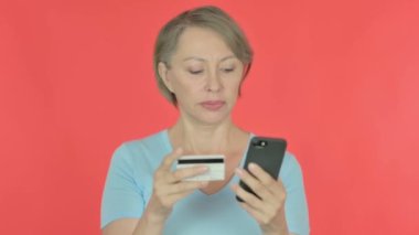 Online Payment Failure for Senior Old Woman on Red Background 