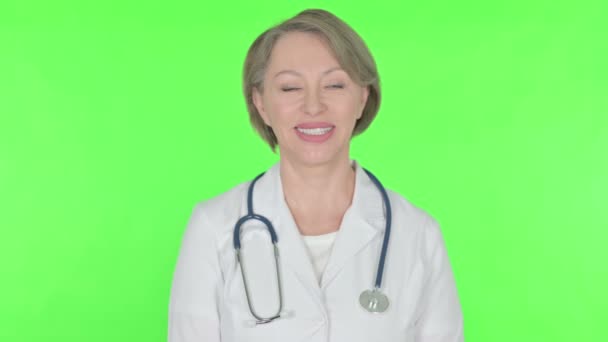 Smiling Senior Female Doctor Green Background — Stok Video