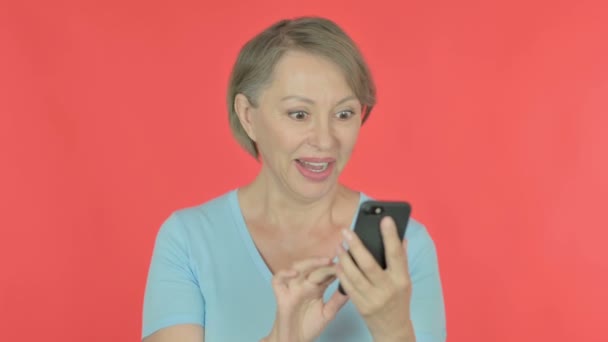 Senior Old Woman Celebrating Smartphone Red Background — Stok video