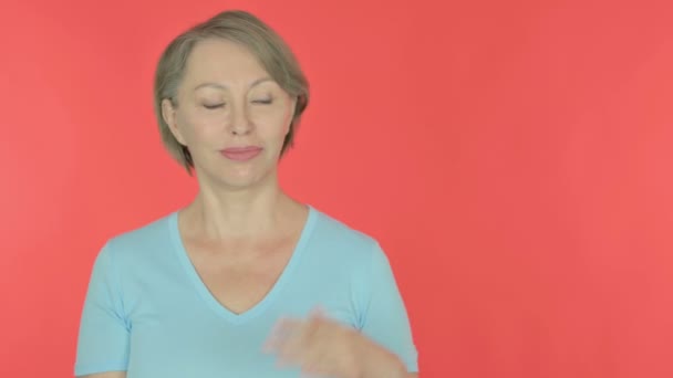 Senior Old Woman Showing Side Red Background — 图库视频影像