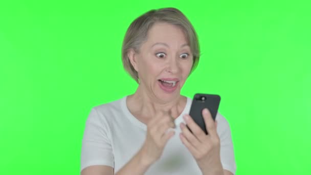 Senior Old Woman Celebrating Smartphone Green Background — Stock Video