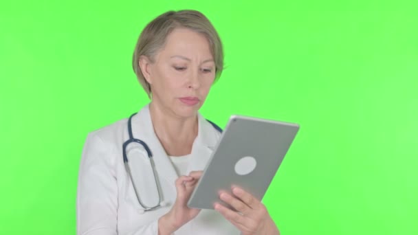 Senior Female Doctor Using Digital Tablet Green Background — Stok Video