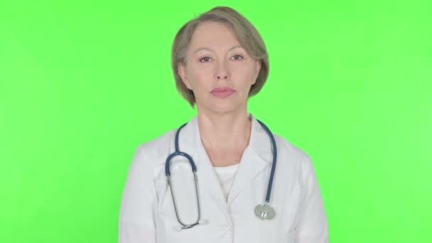 Serious Senior Female Doctor Green Background — 图库视频影像