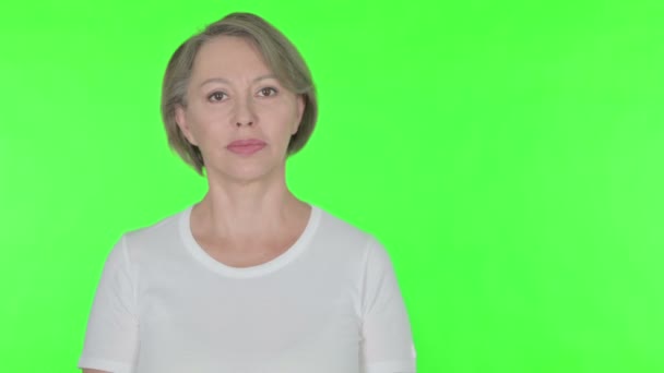 Senior Old Woman Pointing Side Green Background — Stock Video