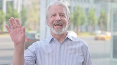 Welcoming Senior Old Man Waving Hand for Hello Outdoor
