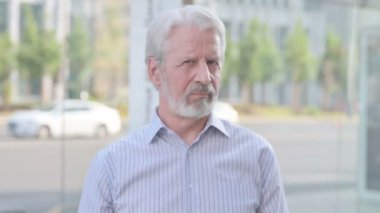Rejecting Senior Old Man Shaking Head in Denial Outdoor