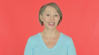 Senior Old Woman Talking on Online Video Call on Red Background 