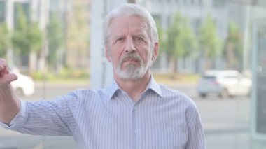 Thumbs Down By Senior Old Man Standing Outdoor