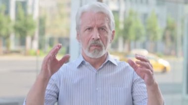 Portrait of Senior Old Man having Headache Outdoor